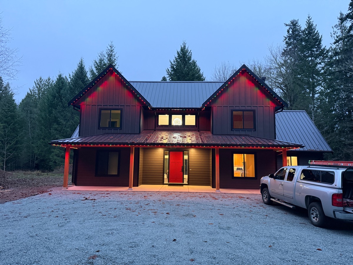 A new farmhouse outlined in red by Gemstone Lights permanent roofline lighting.